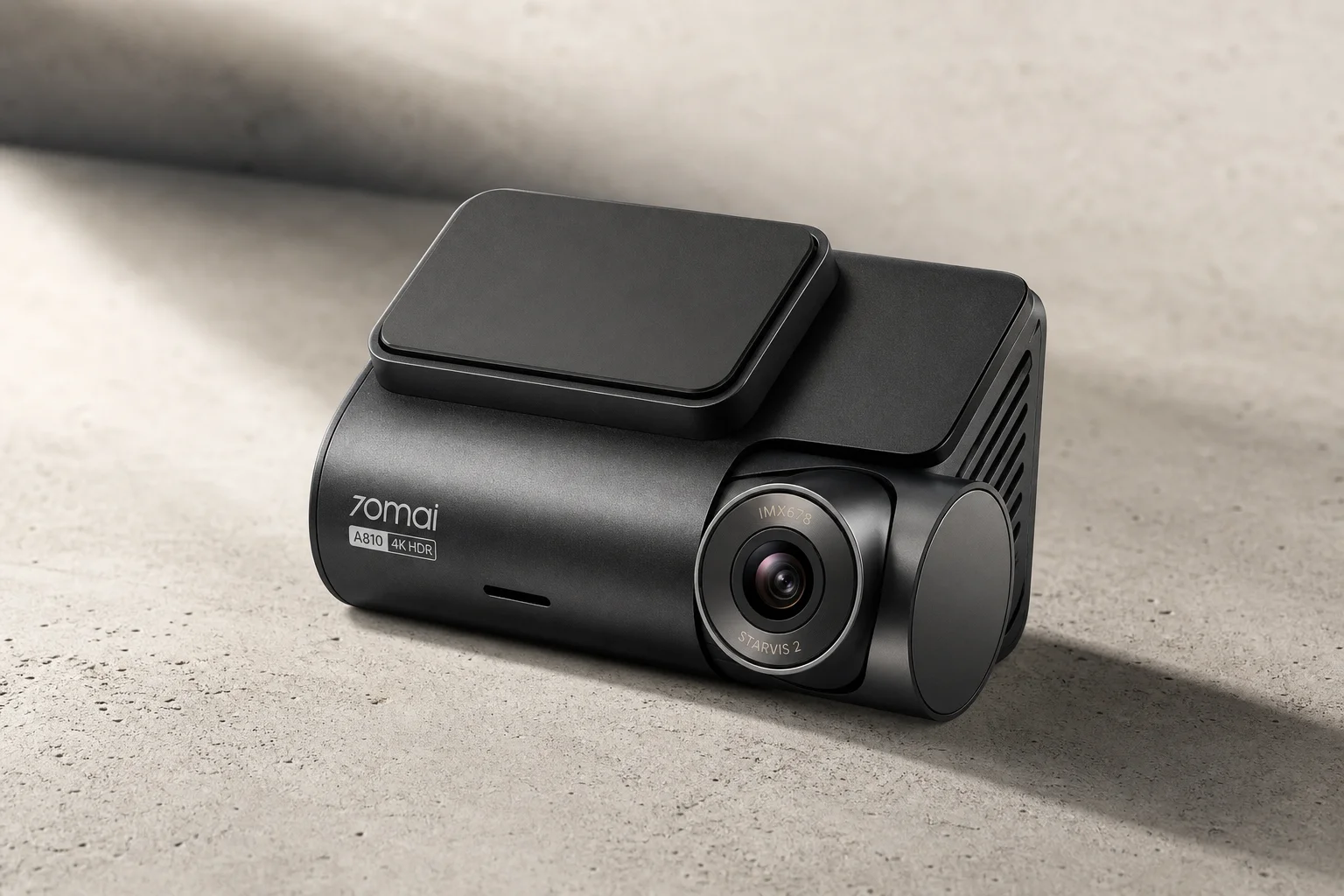 Three 70mai dash cameras A200, A510, and A810 arranged by size on grey surface