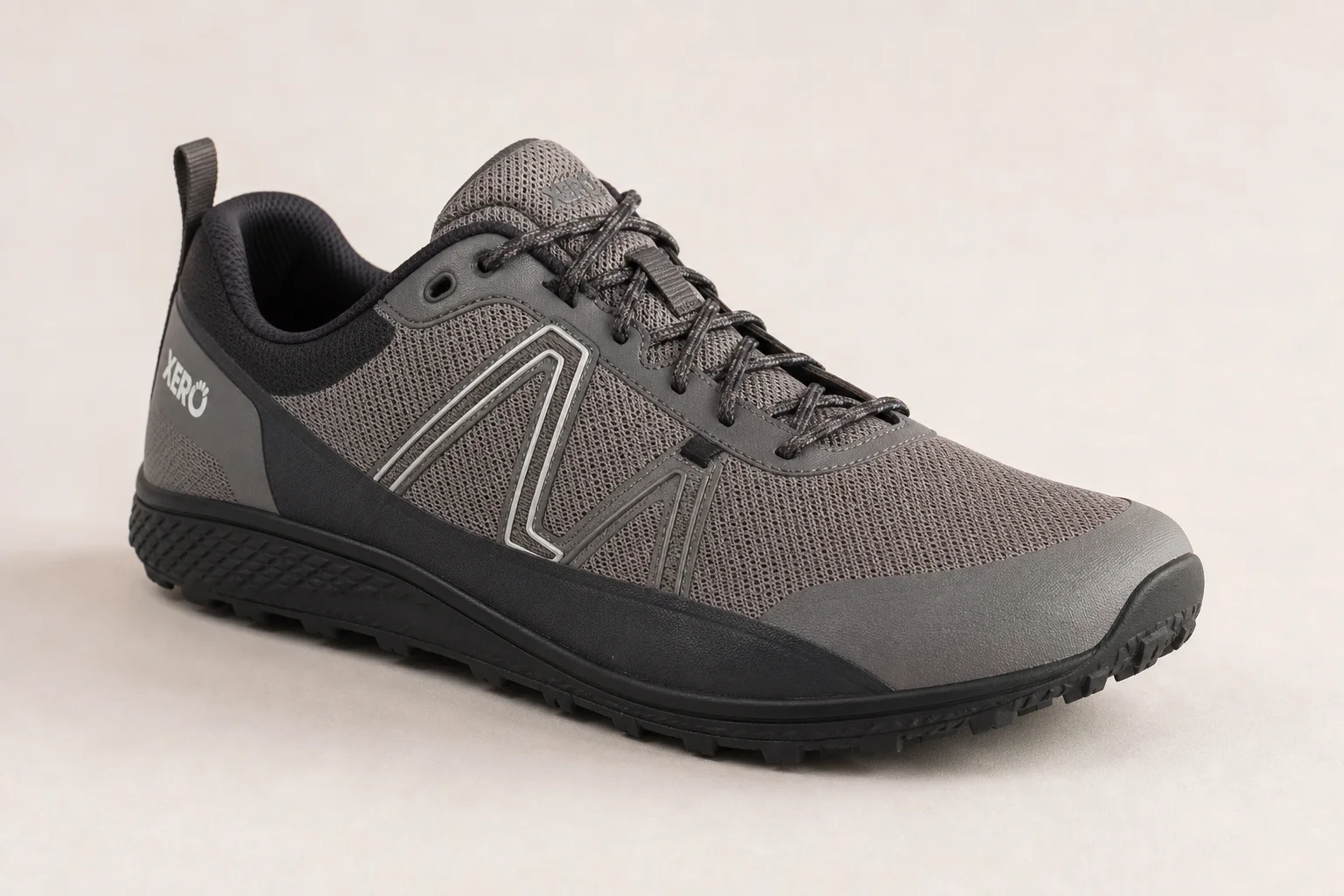 Three wide toe box trail running shoes on concrete surface
