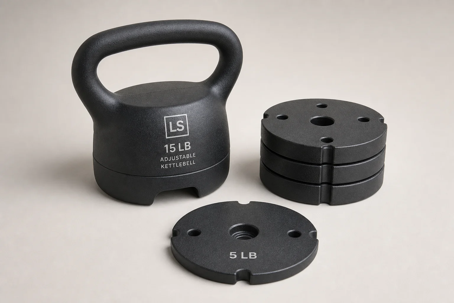 Five kettlebells of varying weights and finishes arranged on concrete surface