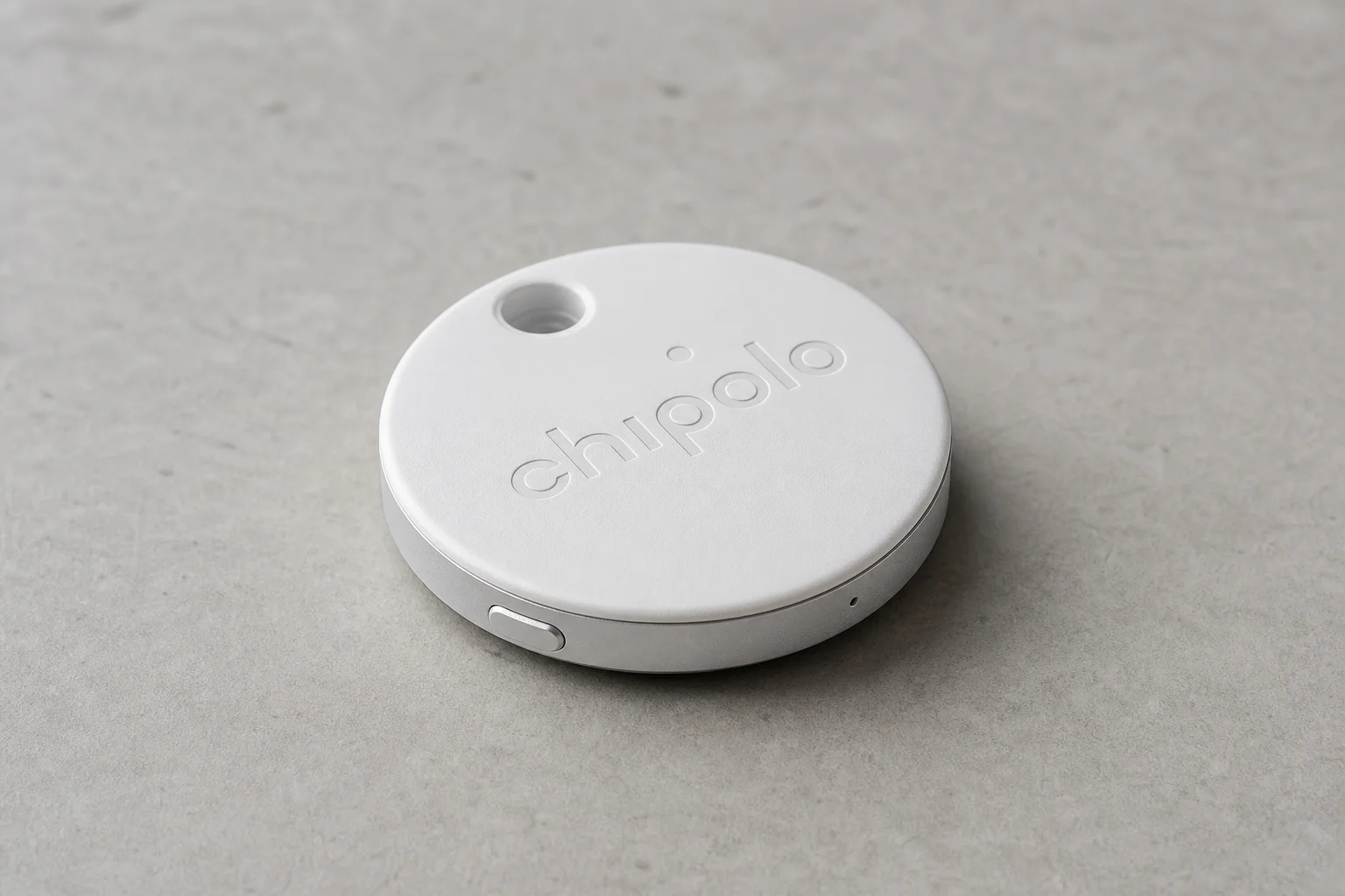 Flat-lay arrangement of 12 essential travel items on grey concrete surface
