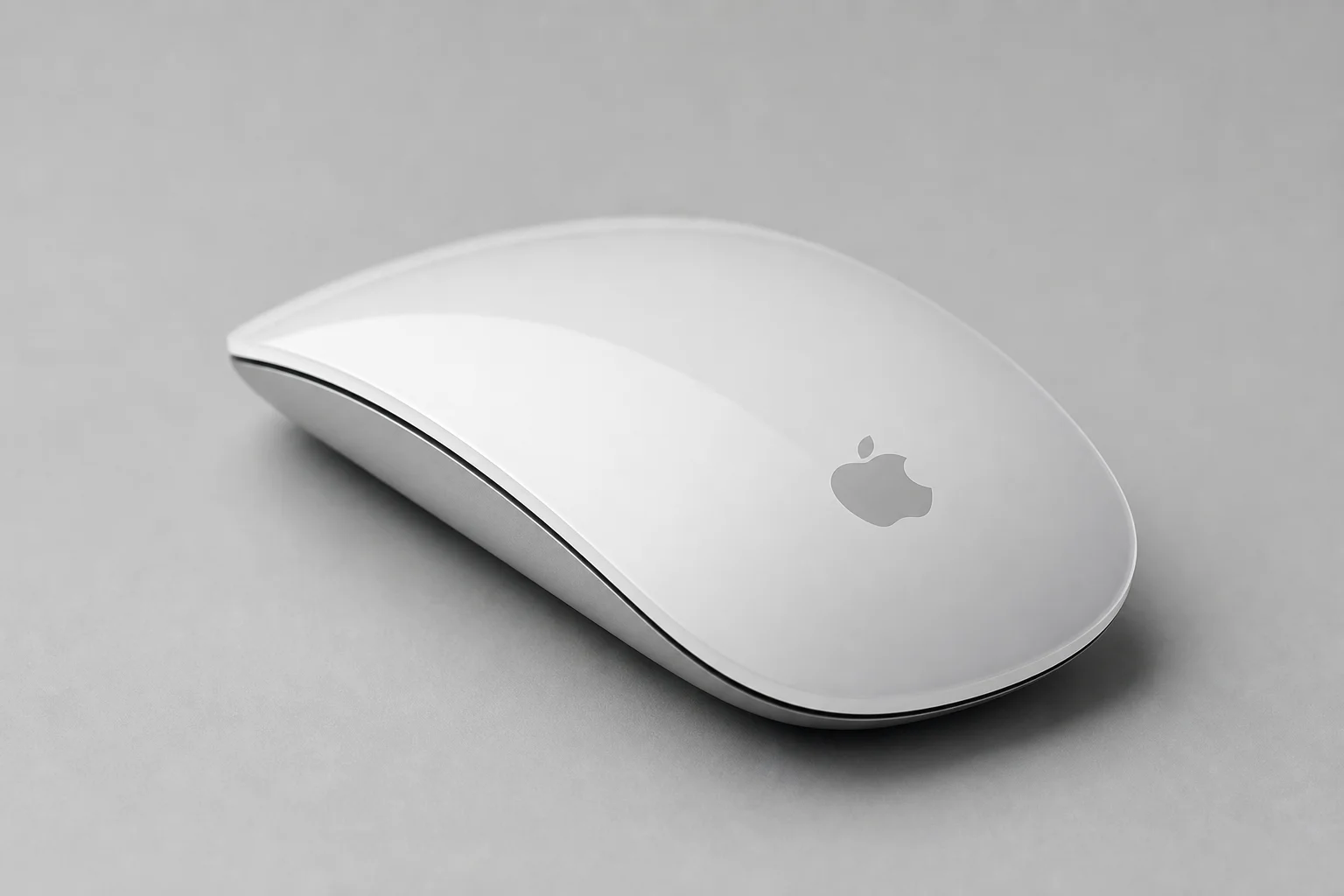 Five computer mice arranged on a concrete surface: Apple Magic Mouse, Magic Trackpad, Logitech G305, Lift, and MX Master 3