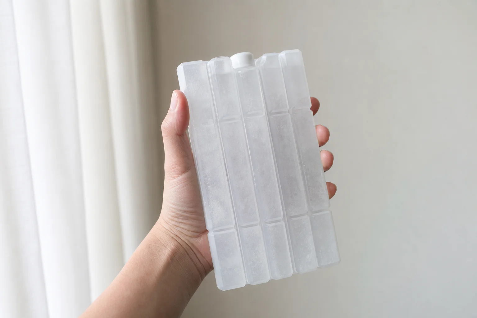 Hand holding Arizona Ice pack demonstrating durability and handling
