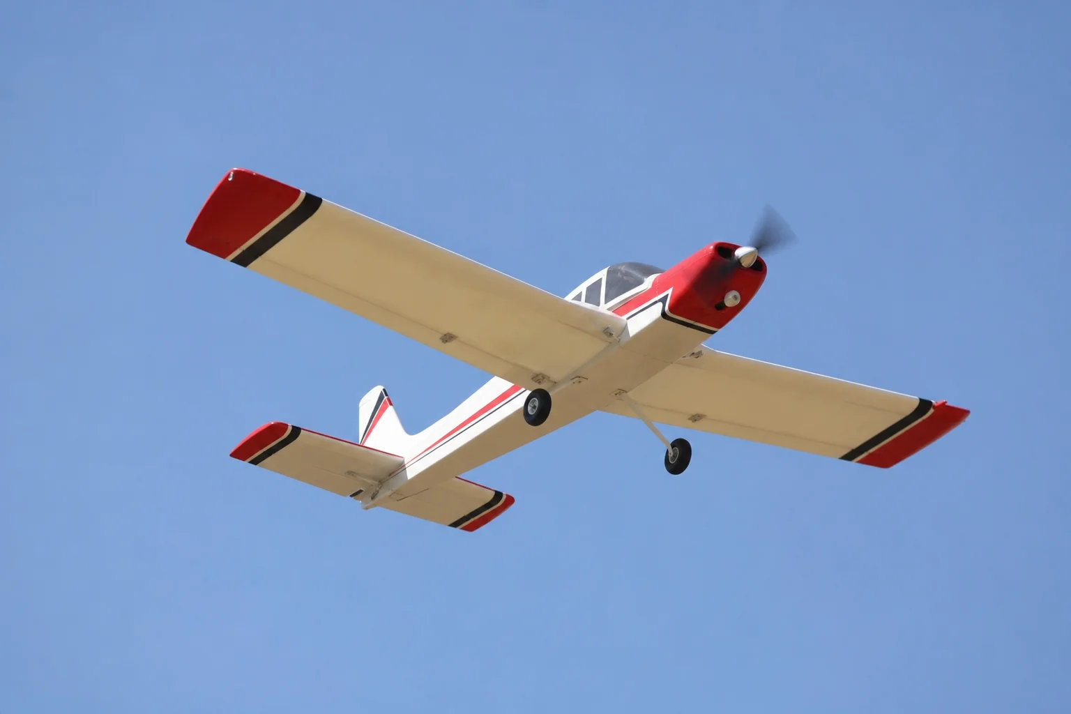 RC aircraft in level flight against a clear sky