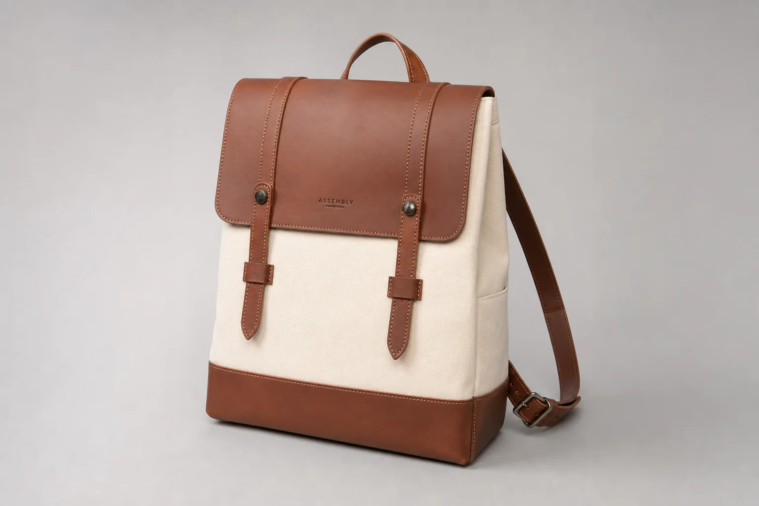 Five backpacks in different styles and colors arranged on concrete surface