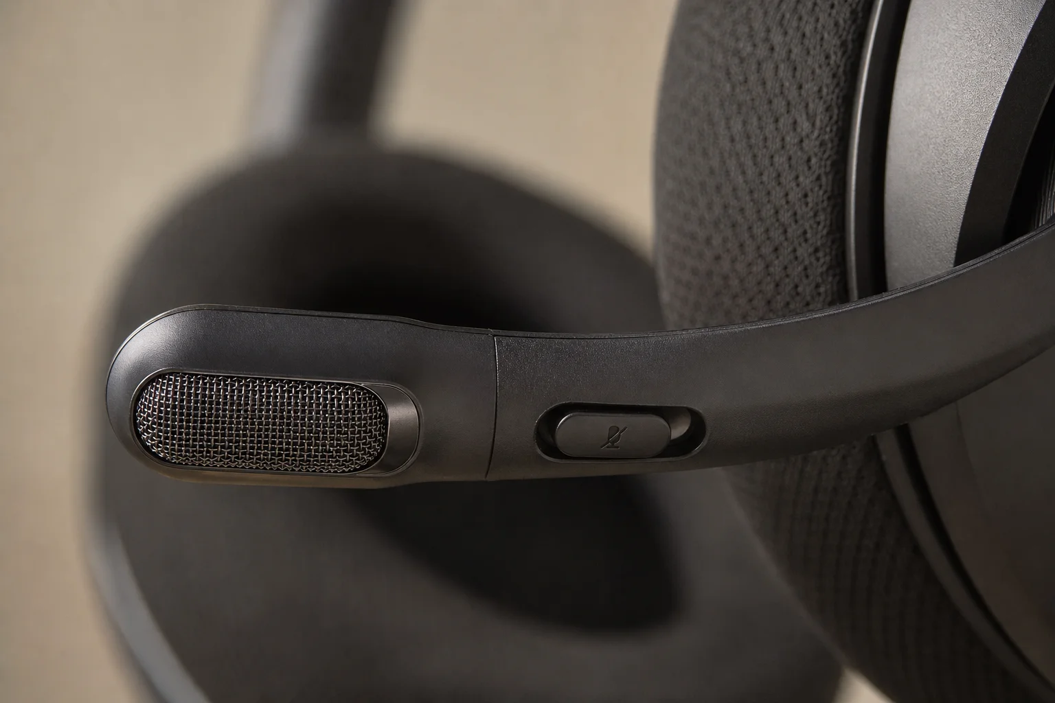 Close-up of integrated microphone boom with metal grille on gaming headset
