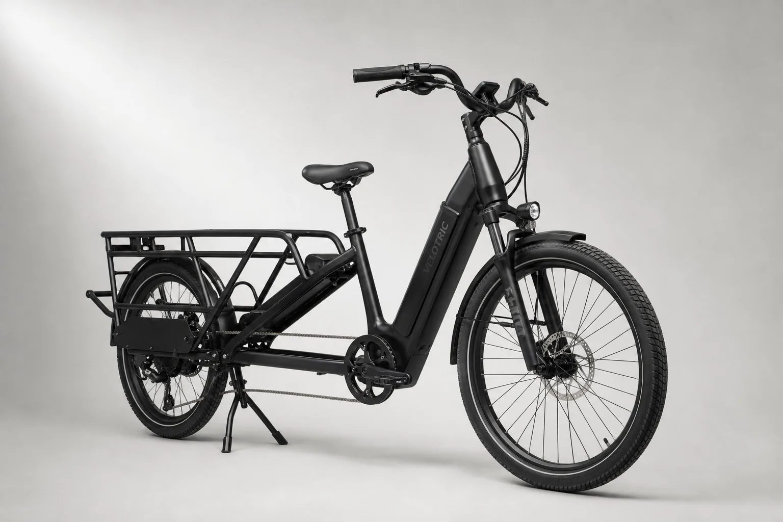 Three electric cargo bikes displayed side by side on neutral backdrop