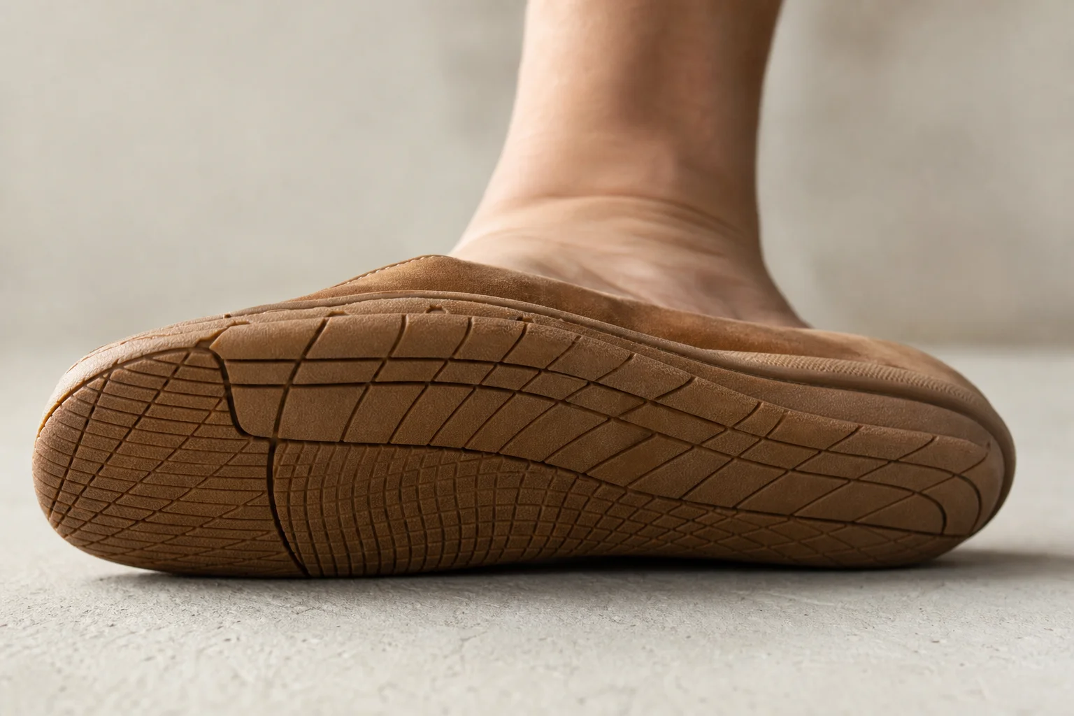 Close-up of barefoot shoe sole showing minimal tread and ground contact