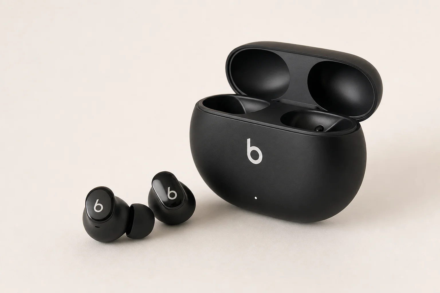 Five wireless earbuds arranged on concrete surface