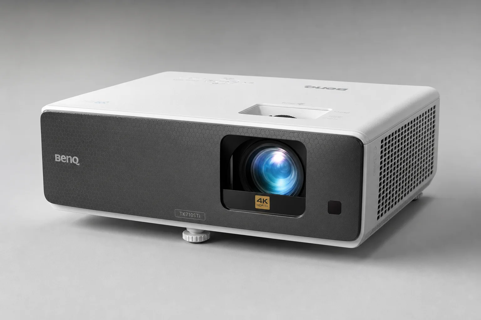 Five home theater projectors arranged by size on a concrete surface