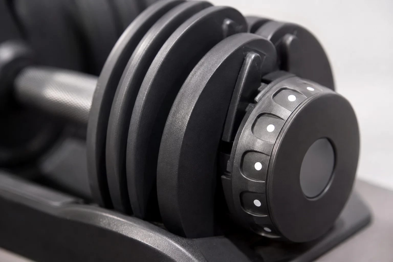 Close-up of dumbbell rotating dial adjustment mechanism with numbered selections
