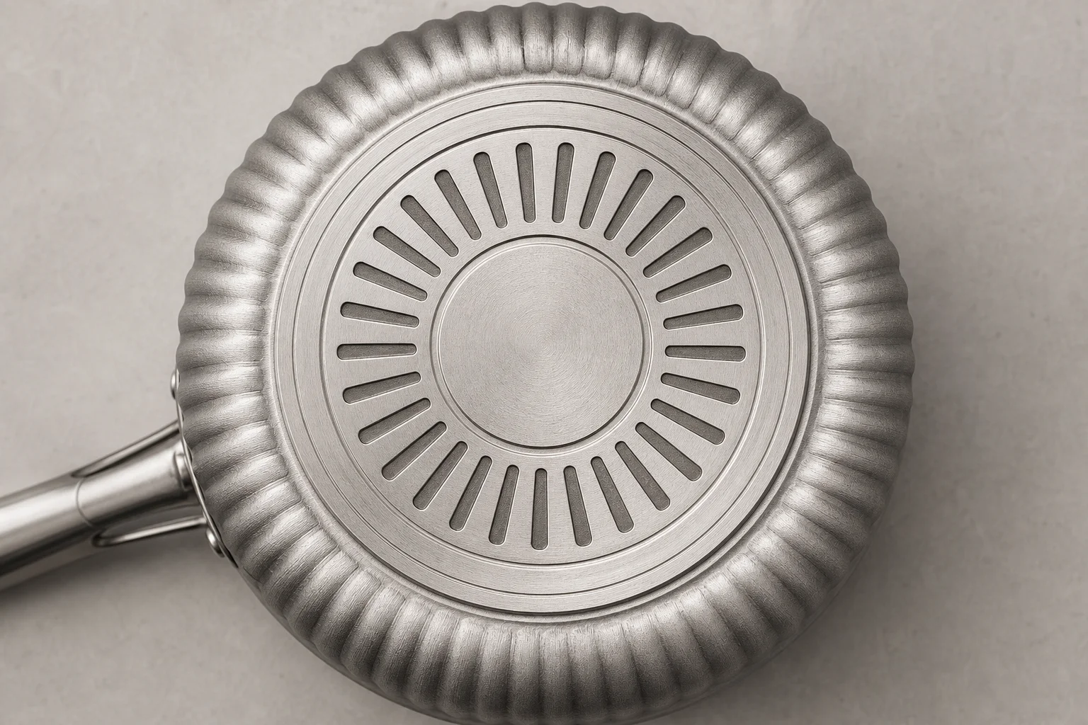 Heat exchanger pot base showing corrugated ring design for improved heat transfer