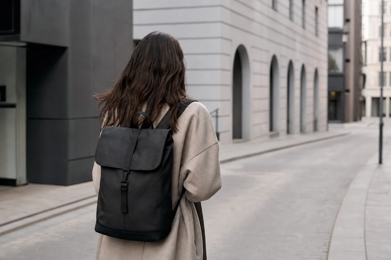 Person wearing a backpack while walking through an urban environment