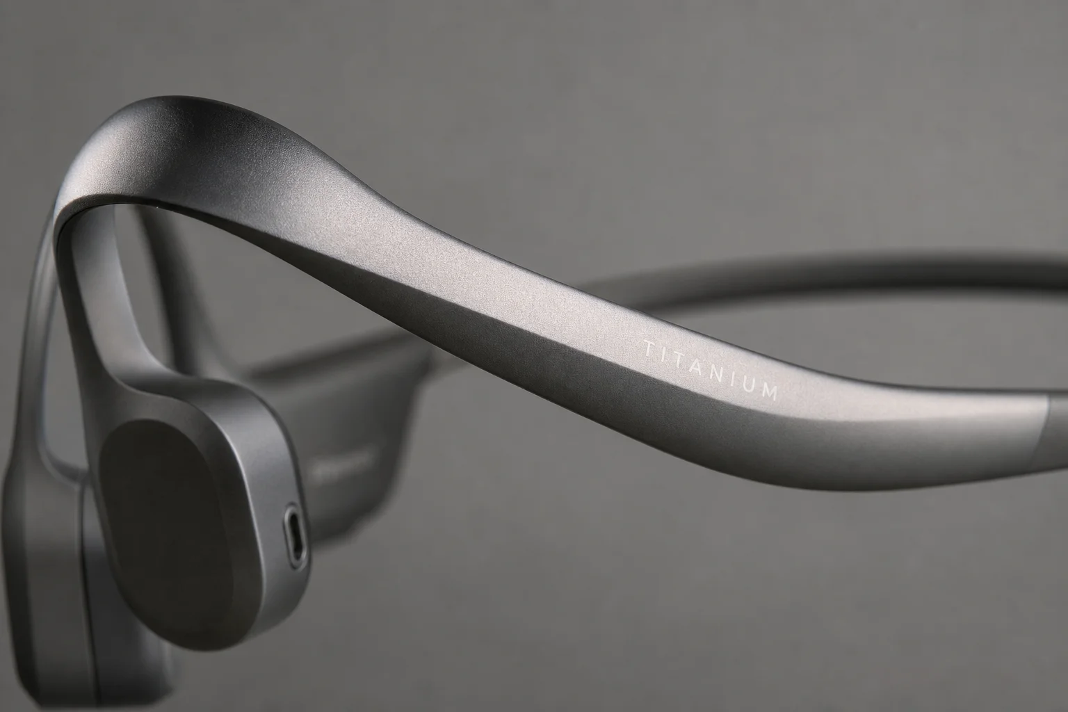 Close-up of bone conduction headphone frame showing titanium construction