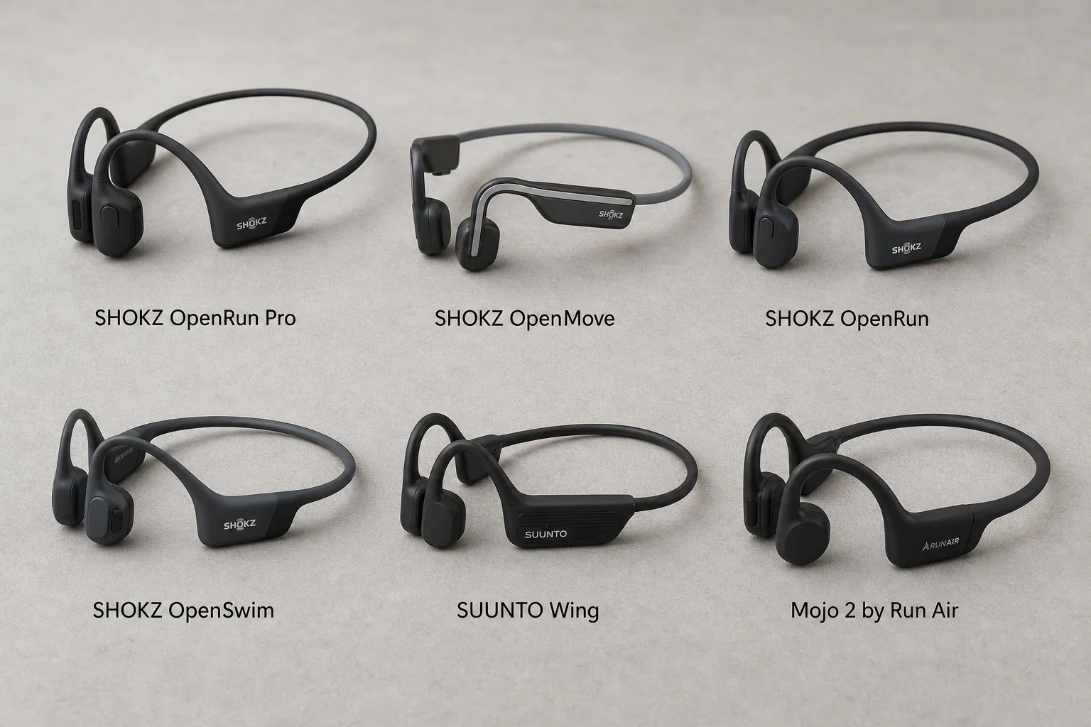 Six bone conduction headphones arranged on concrete surface showing different models and designs