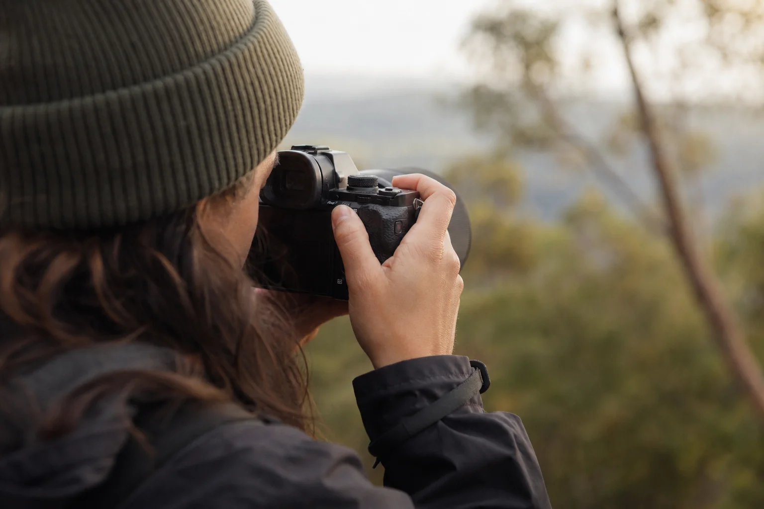 Photographer composing a shot through an electronic viewfinder