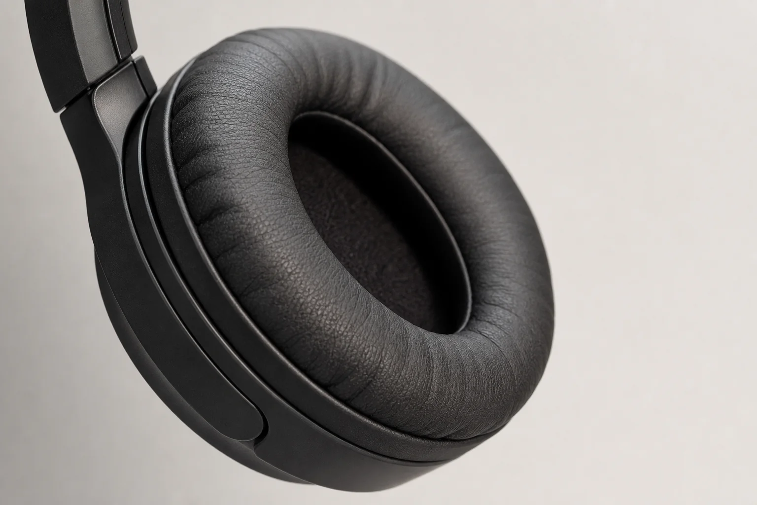 Gaming headset ear cup showing cushioning and fit on neutral background