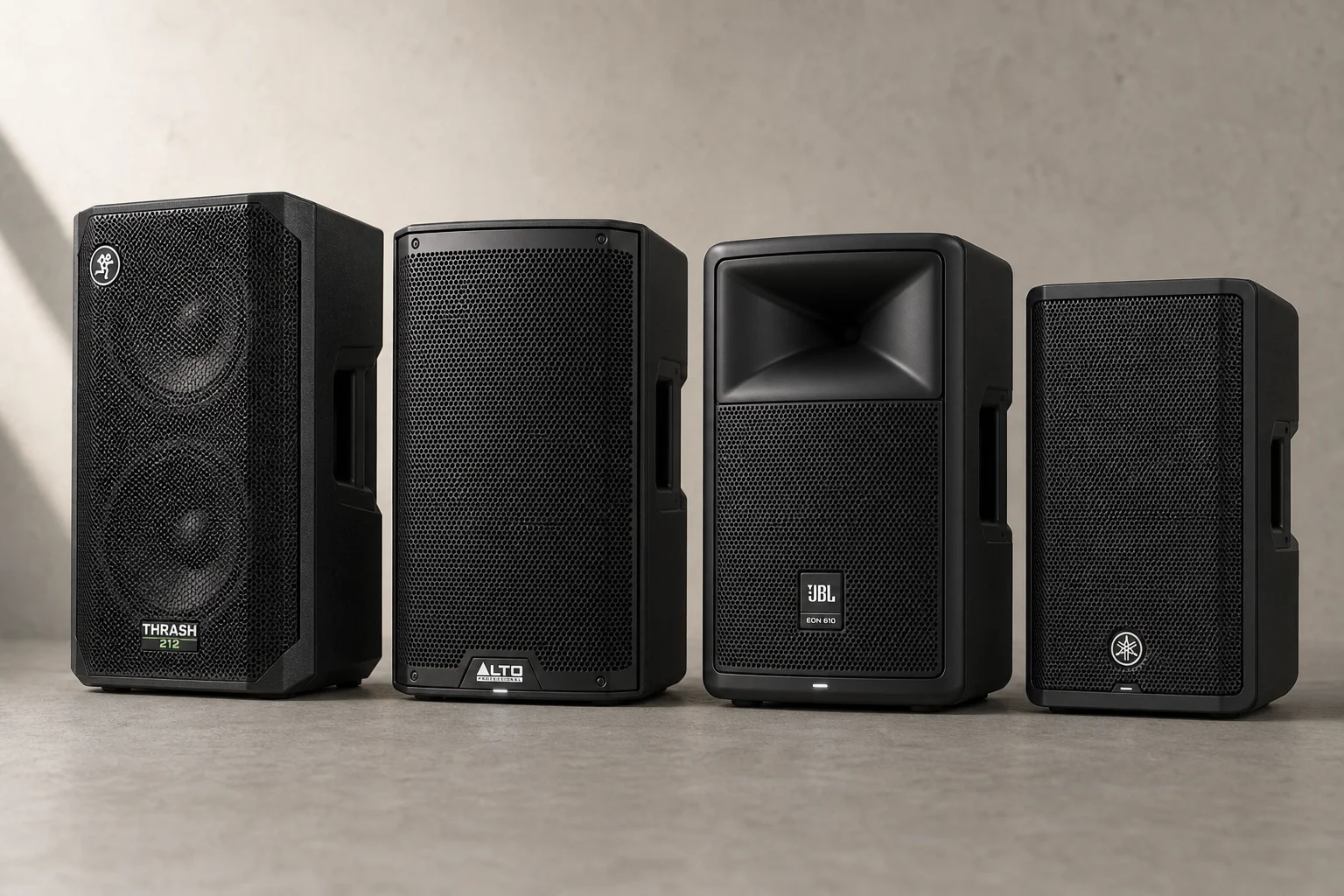 Four budget PA speakers lined up on concrete: Mackie Thrash 212, Alto TS410, JBL EON 610, Yamaha DBR10