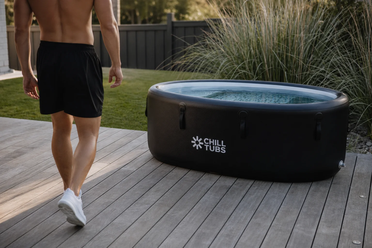 Athlete entering an ice bath tub in a backyard recovery setup