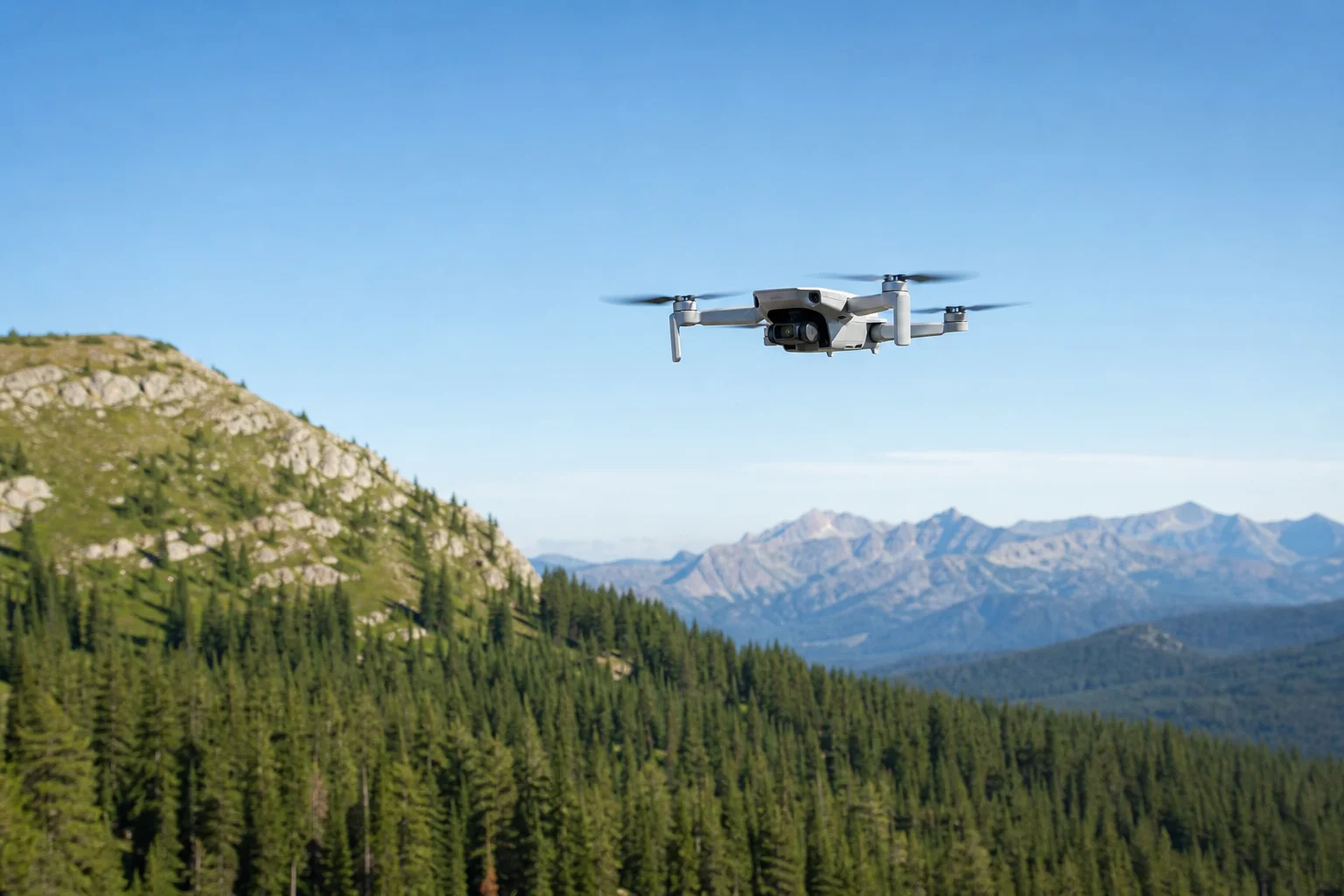 Compact drone hovering above outdoor landscape with trees and sky