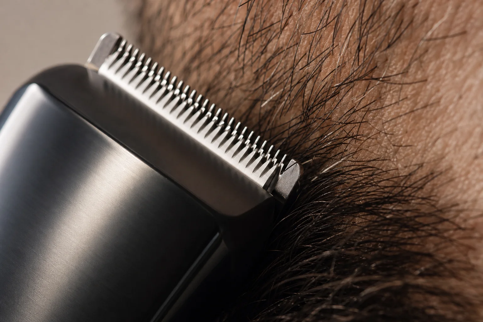 Close-up of stainless steel trimmer blades cutting facial hair with precision