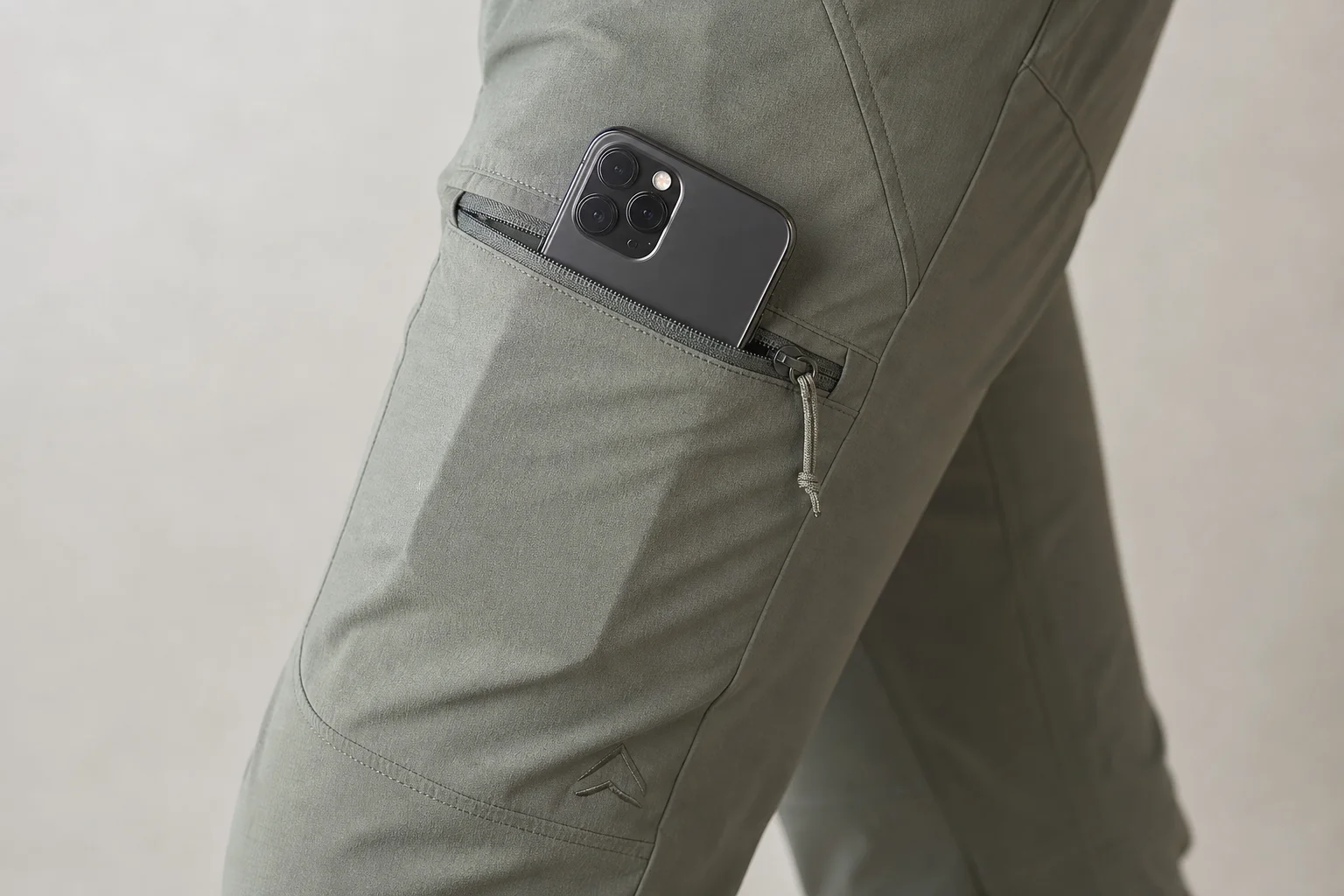Close-up of hiking pants pocket with zippered thigh storage