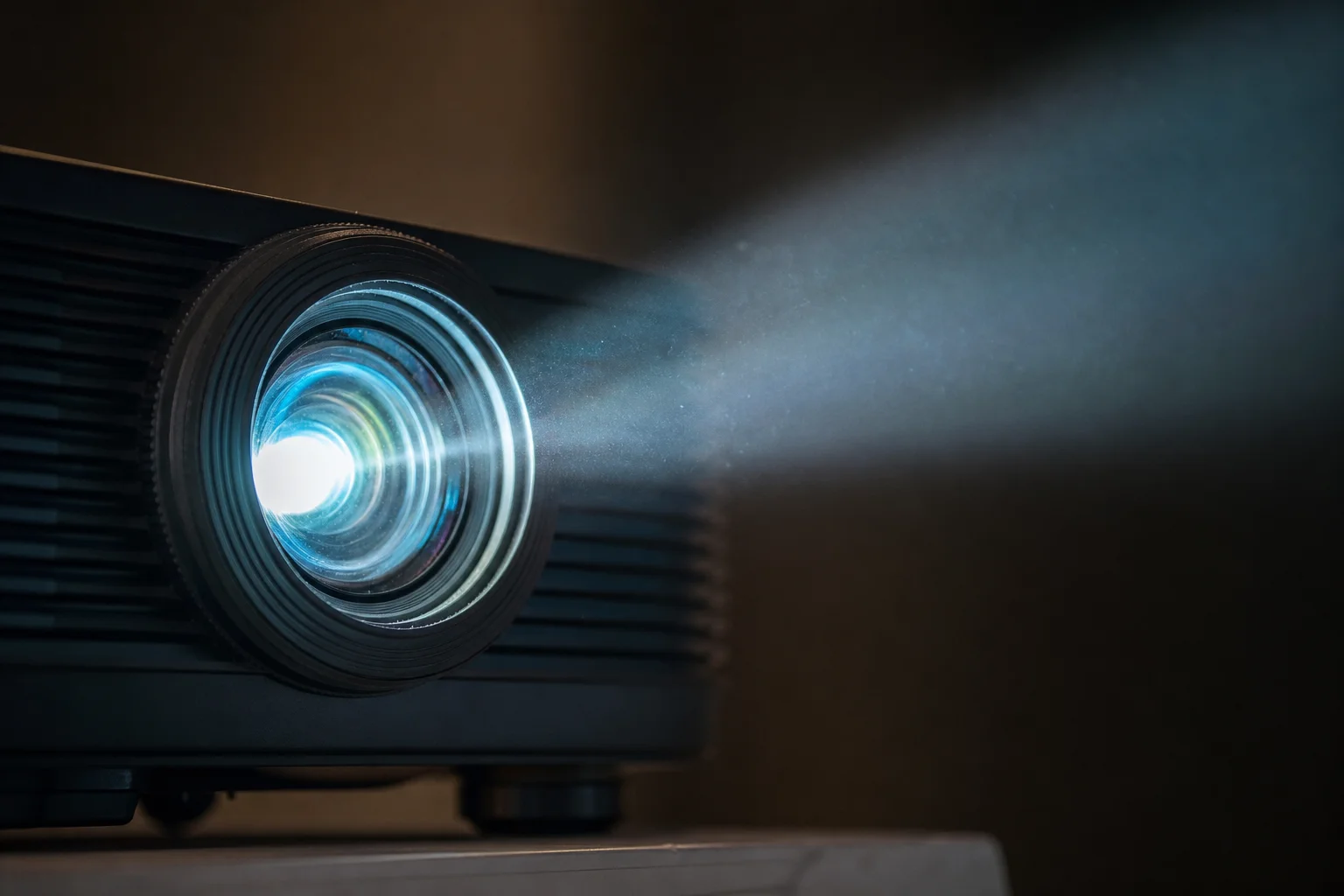 Projector lens with visible light beam in dark room