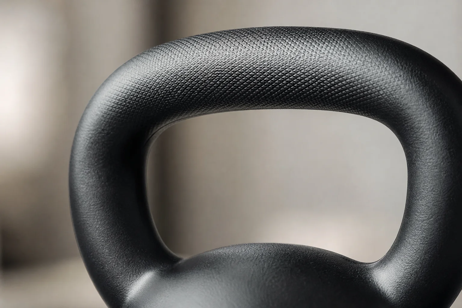 Close-up of kettlebell handle grip texture and coating