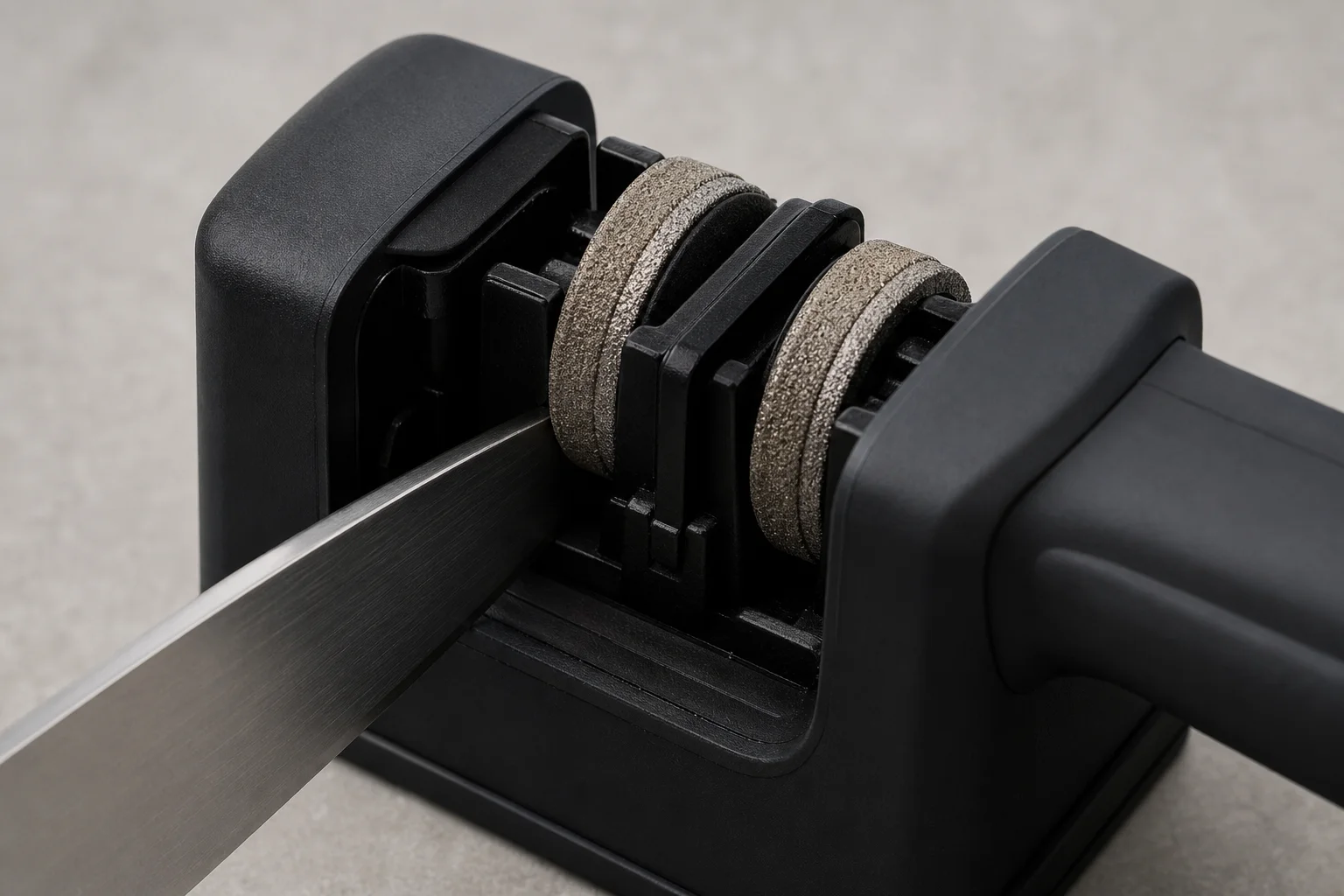 Manual knife sharpener with slots showing diamond grit wheels