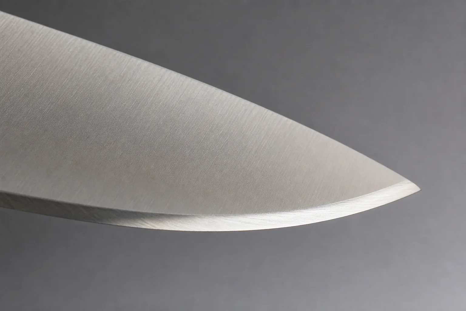 Close-up of a sharp kitchen knife blade edge in natural light