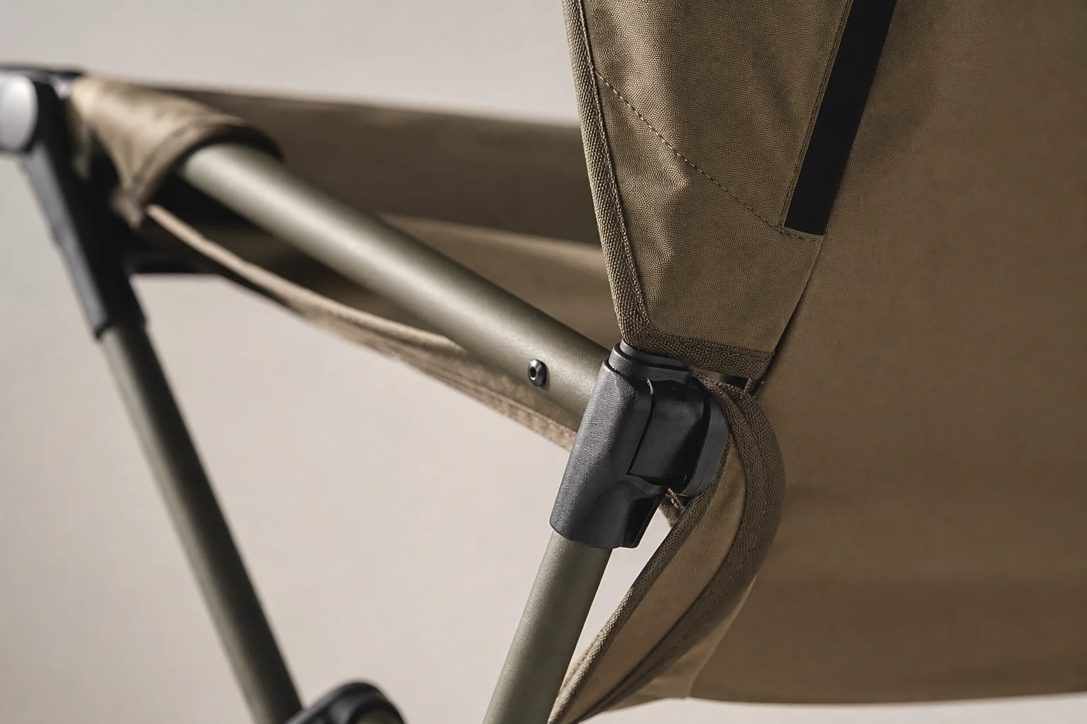 Close-up of camping chair frame showing pole assembly and fabric attachment