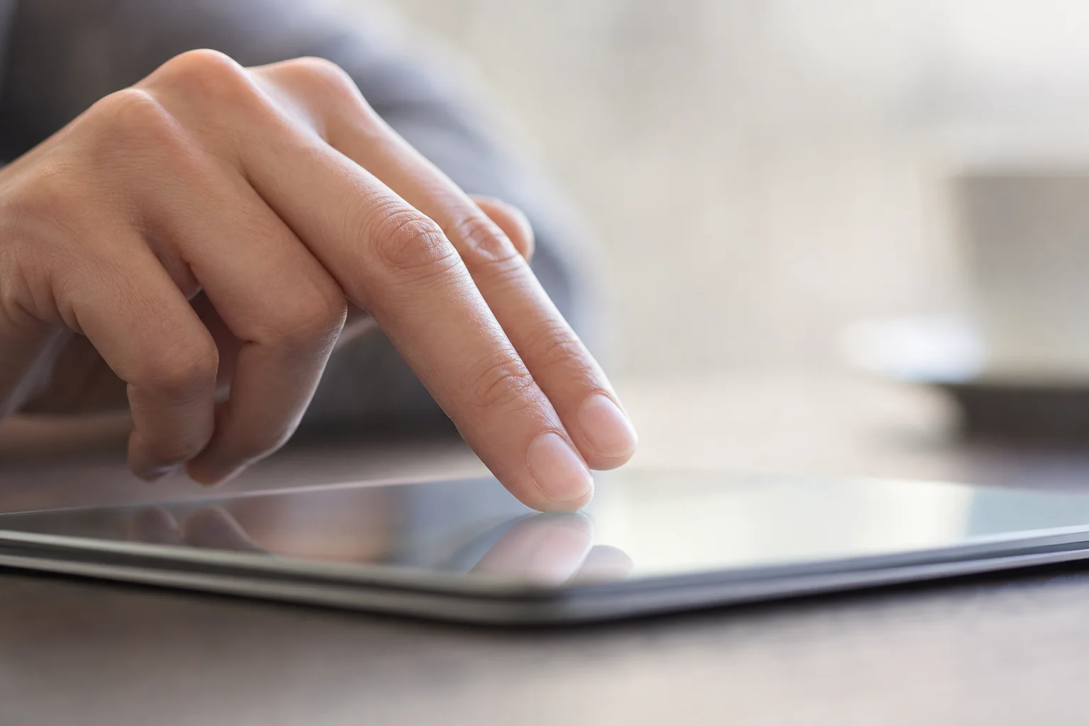 Hand performing two-finger gesture on glass trackpad surface