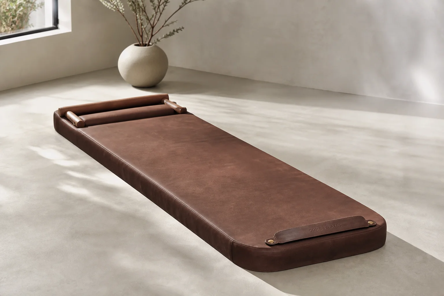 Premium pilates reformer mat with wooden bars and leather cover in a studio