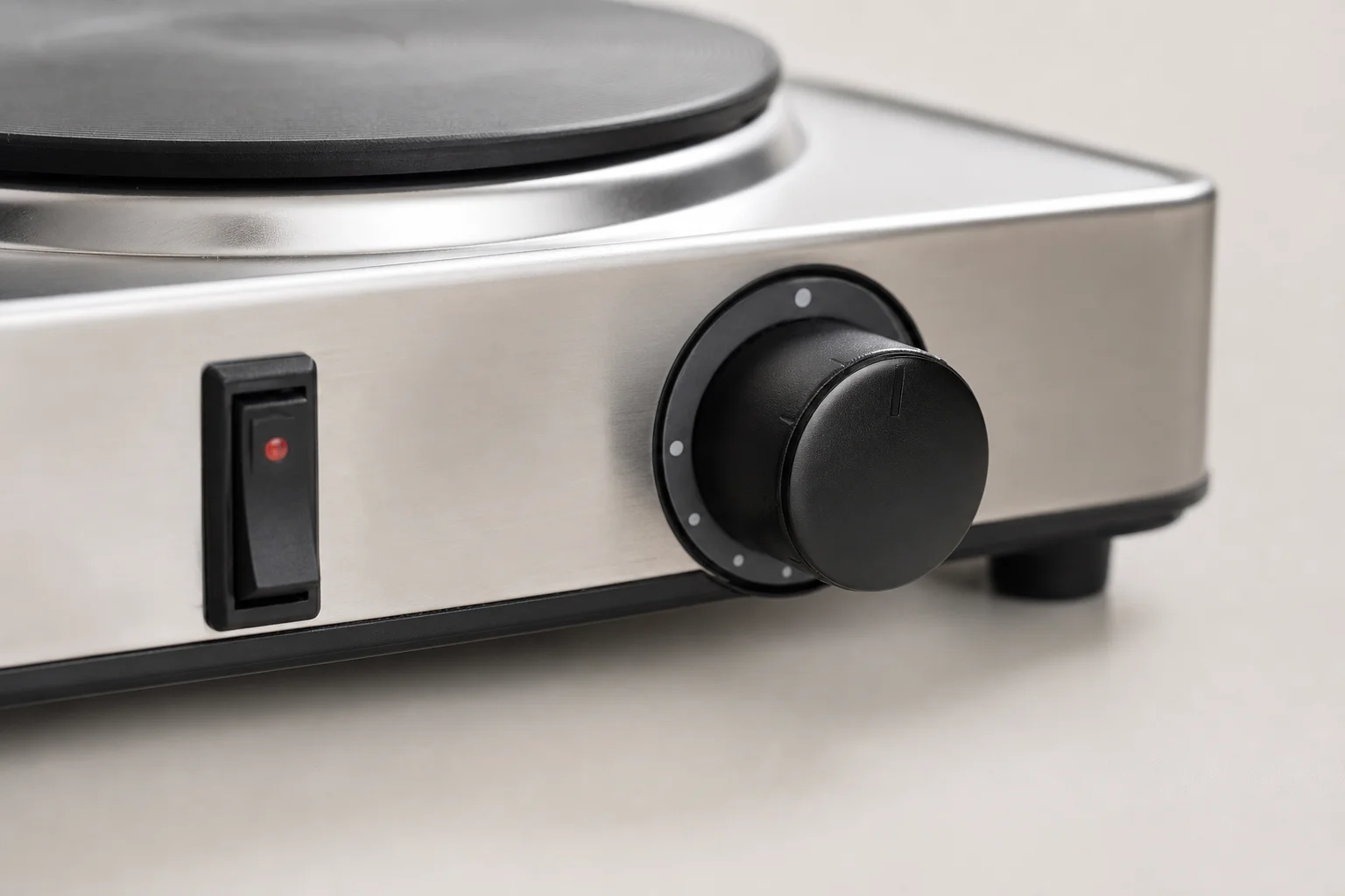 Close-up of electric burner control dial with heat level settings