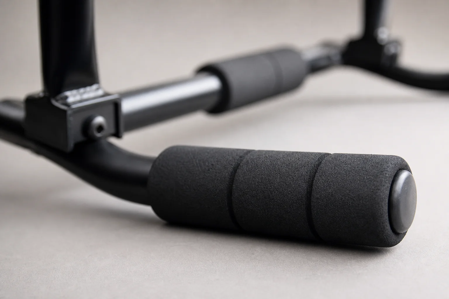 Close-up of foam grip padding on a pull-up bar showing texture and quality