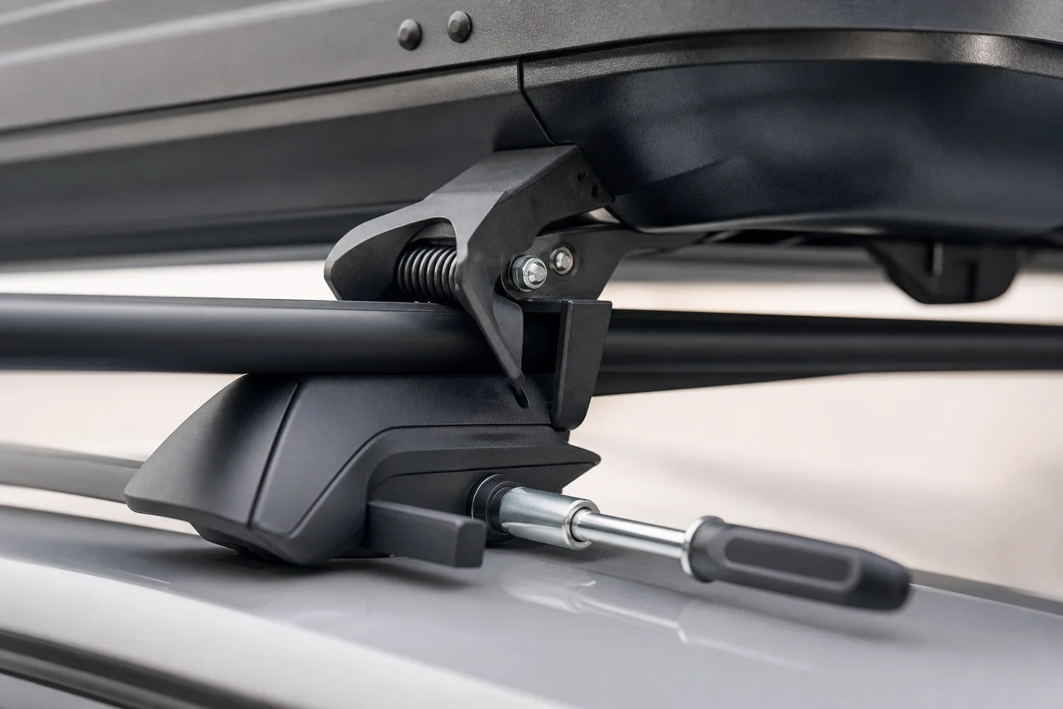 Close-up of cargo box mounting system with claw mechanism and tool