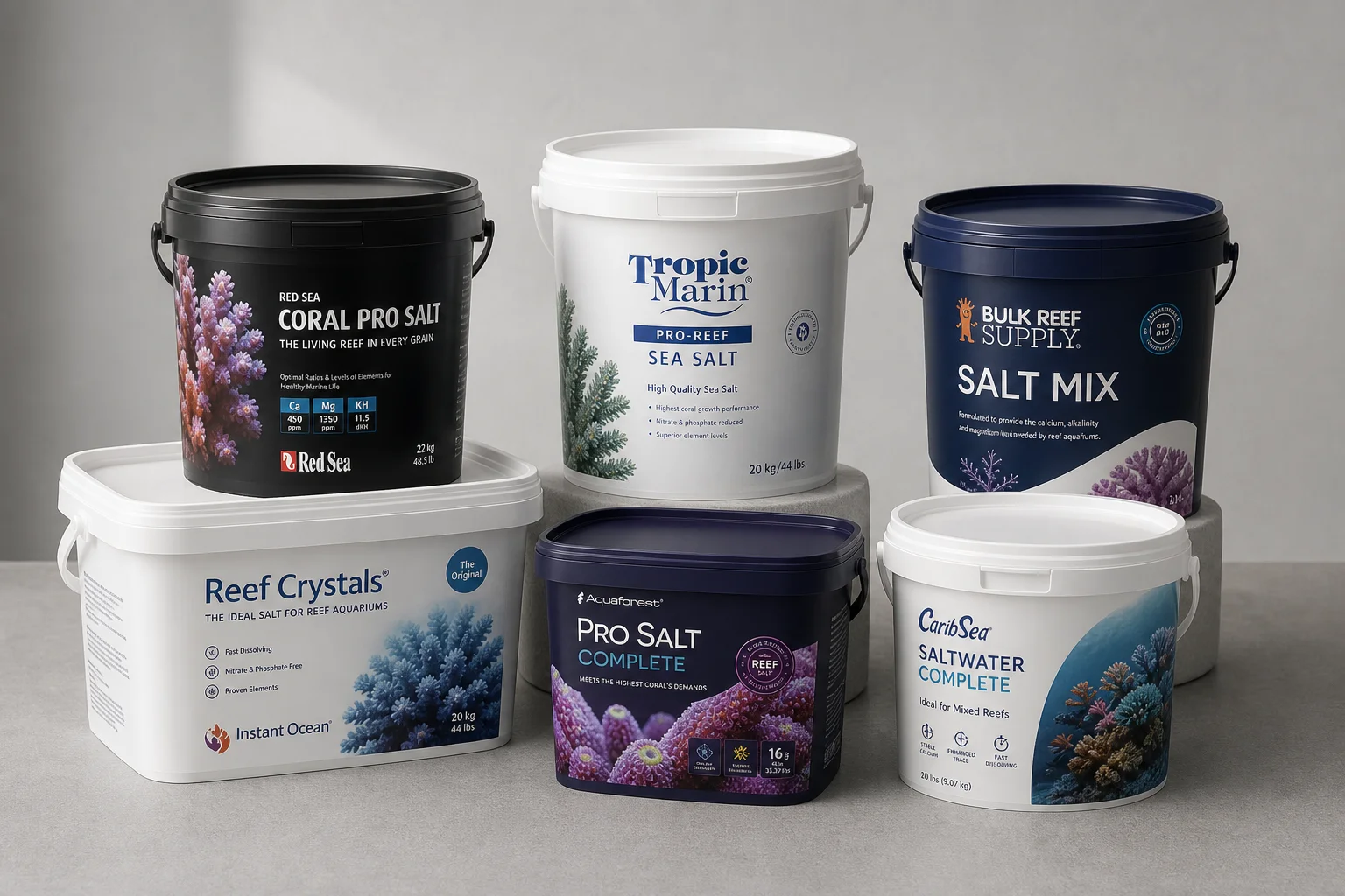 Collection of six saltwater aquarium salt mix buckets on grey surface
