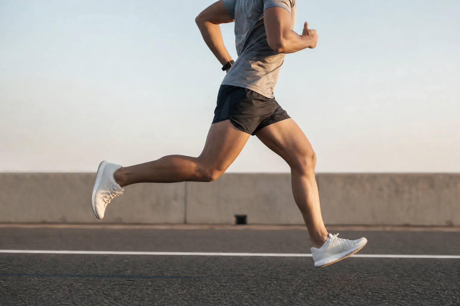 Runner in motion on a track or road surface