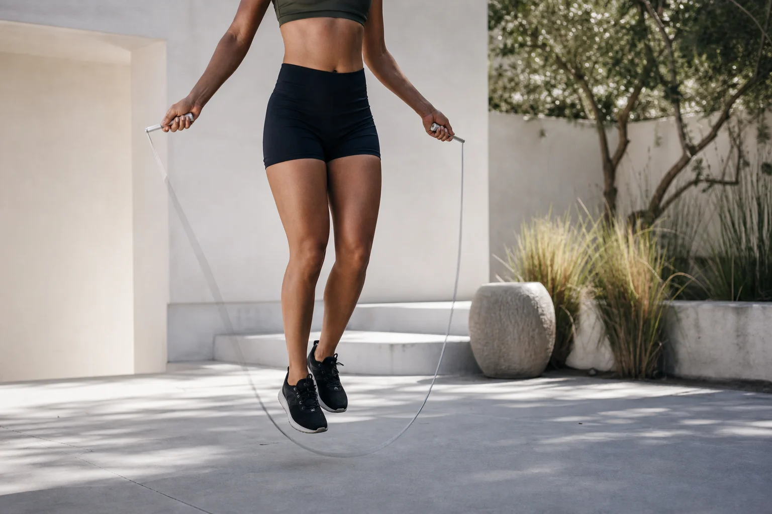 Athlete performing speed jumps with aluminum rope in outdoor setting