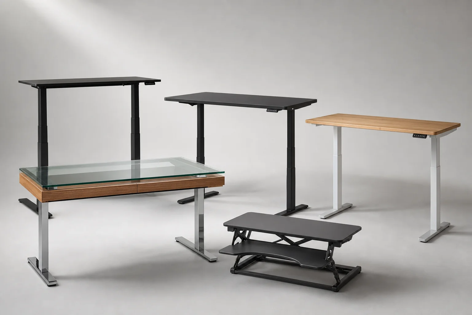 Five standing desks of varying styles and sizes arranged on neutral background