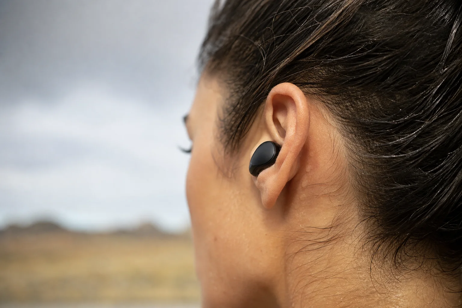 Close-up of earbud fit and comfort in human ear during outdoor activity