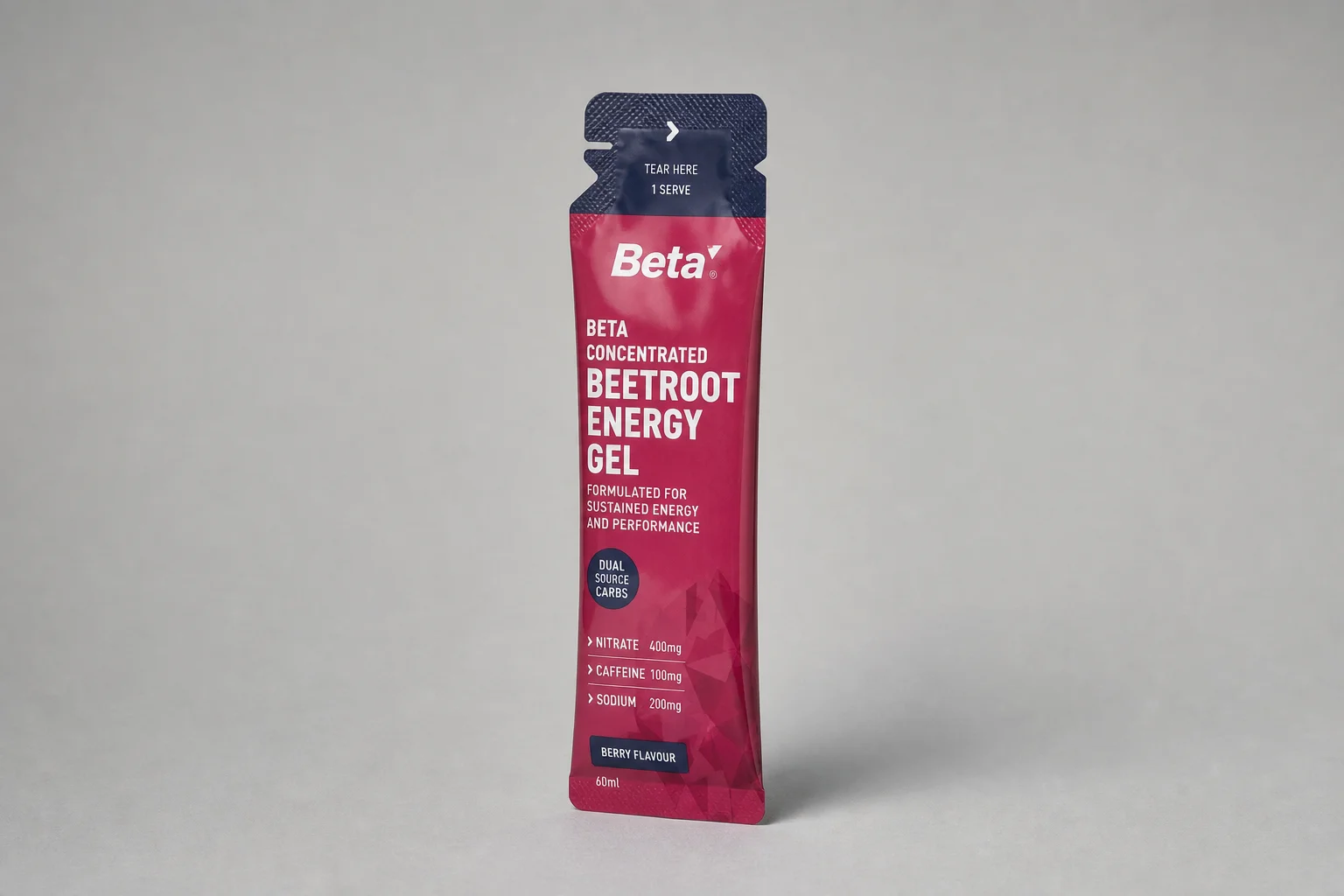 Thirteen energy gel packets arranged in a grid on concrete surface