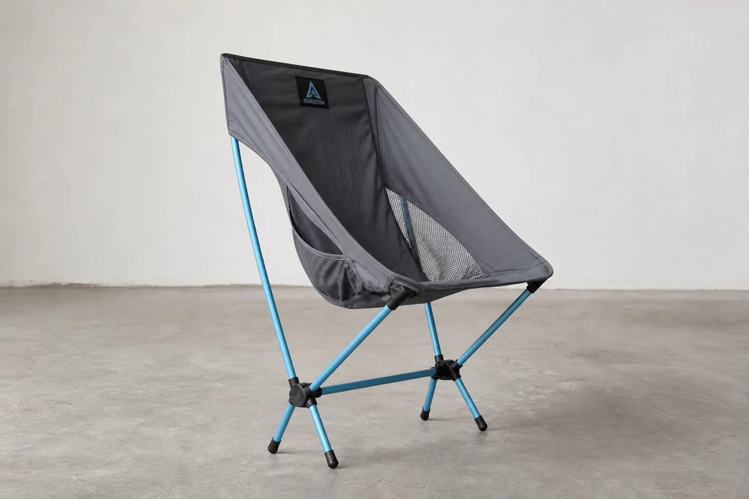 Five lightweight camping chairs arranged on concrete surface showing design variety
