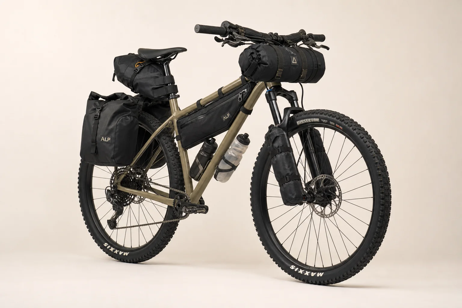 Fully loaded hardtail mountain bike with bikepacking gear on neutral backdrop