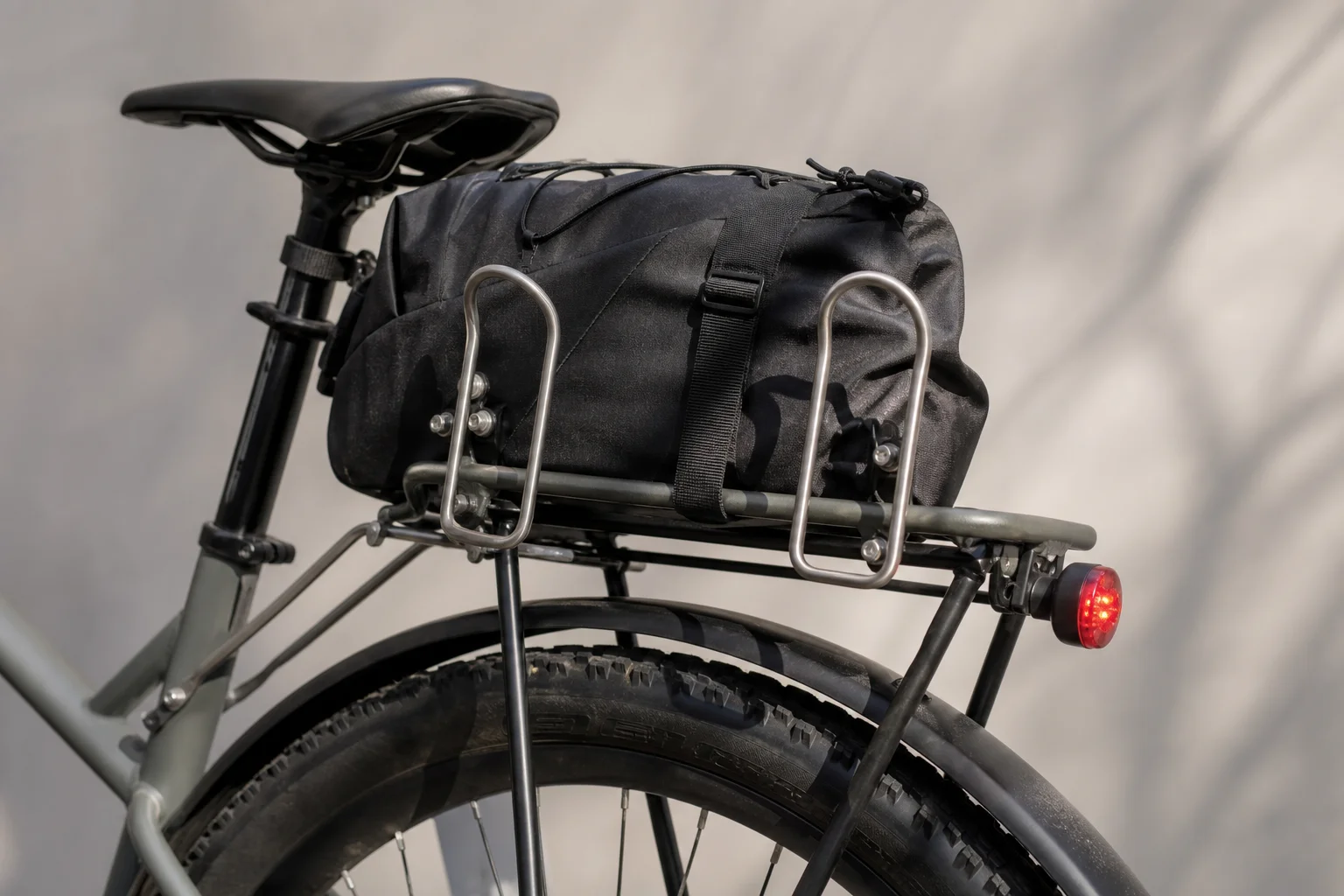 Rear rack with seat bag, bottle cages, and blinky light mounted on hardtail