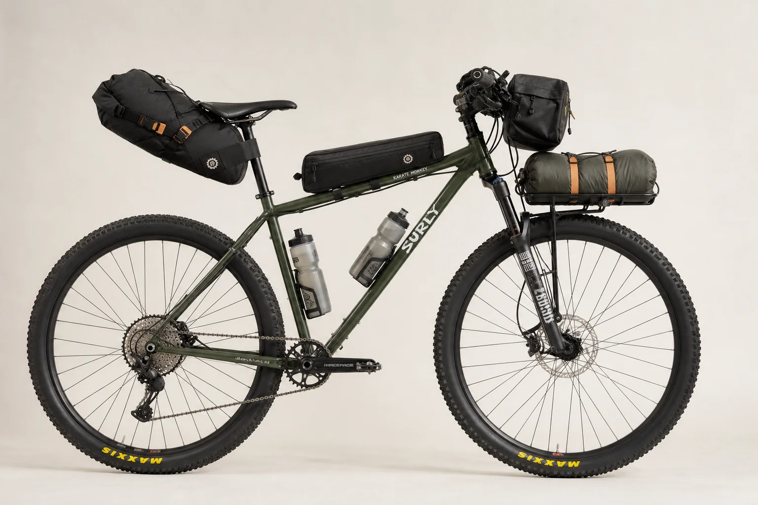 Fully loaded hardtail mountain bike with bikepacking bags and water bottles