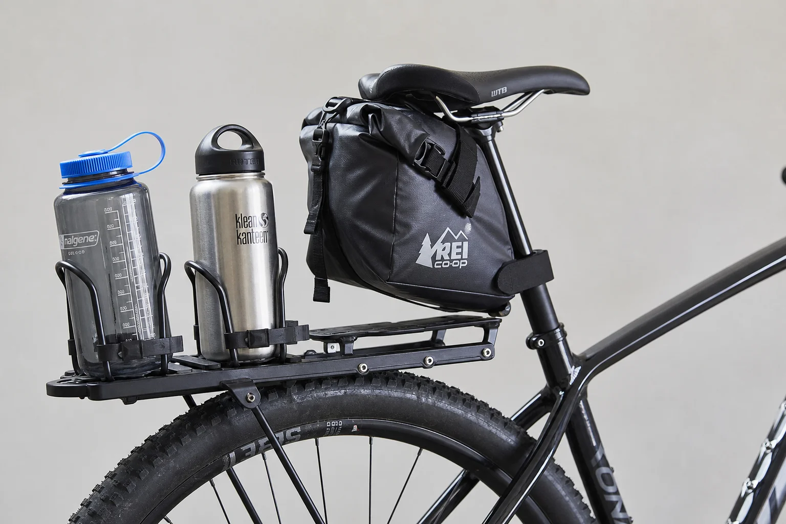 Rear rack with bottle cages and saddle bag on hardtail mountain bike