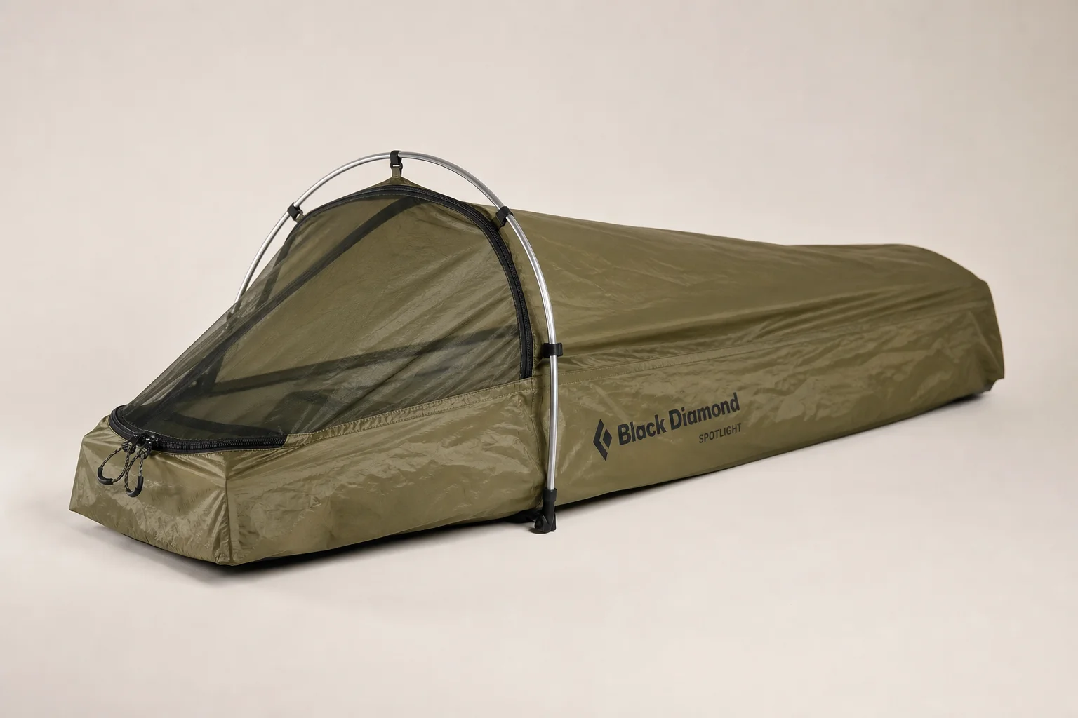 Five bivvy bags displayed in a row on concrete surface showing different designs and colors