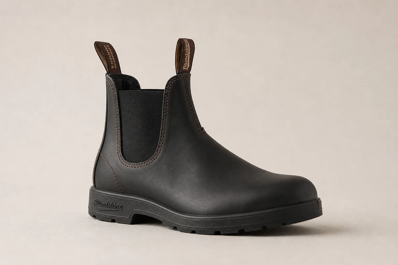 Collection of diverse winter boots arranged on concrete surface