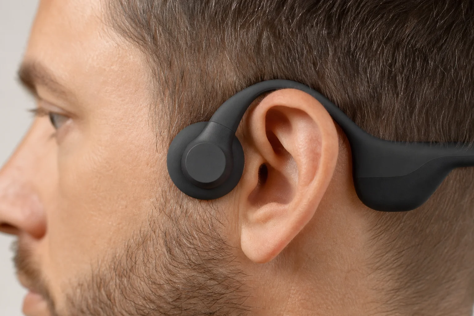 Bone conduction transducer positioned on temporal bone near ear