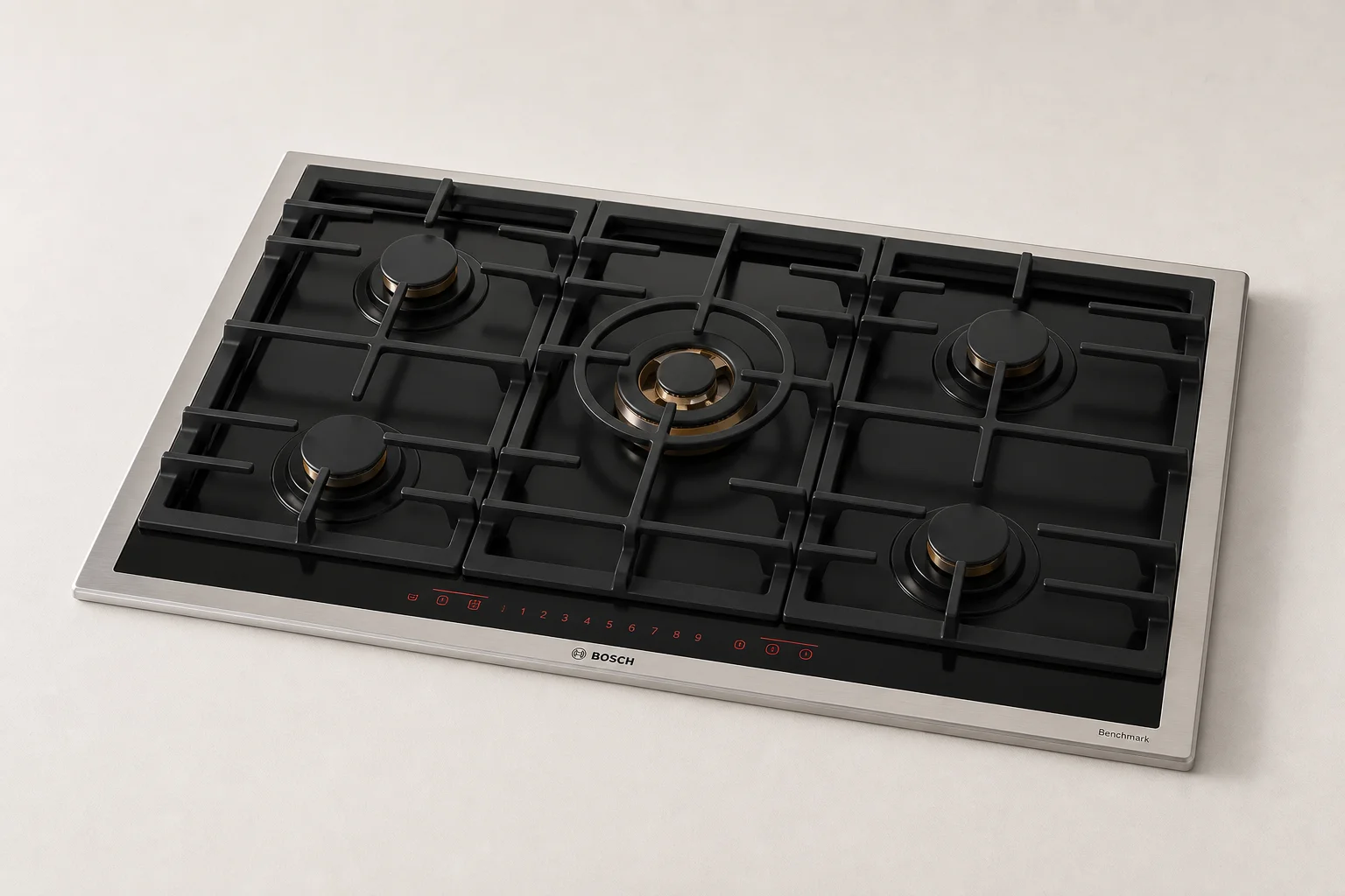 Five electric cooktops displayed in a line showing different designs and finishes